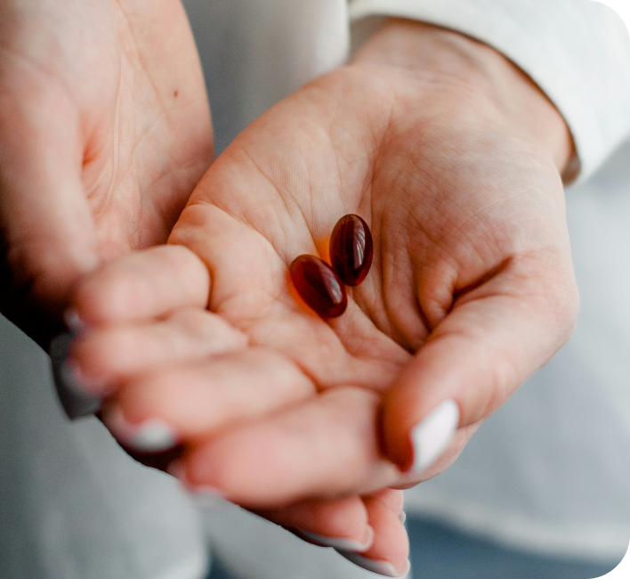 Healthcare professional holding medication capsules in cupped hands