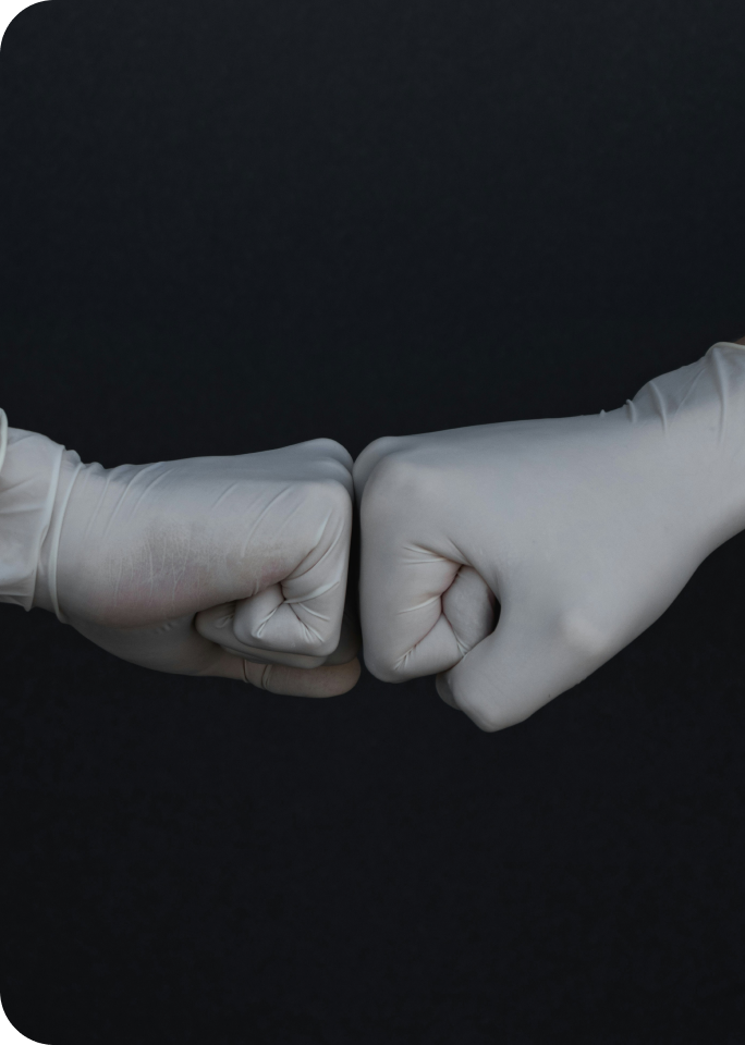 Two hands doing a fist bump representing healthcare partnership and collaboration